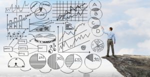 Man analyzes various business charts and graphs drawn on a transparent board.
